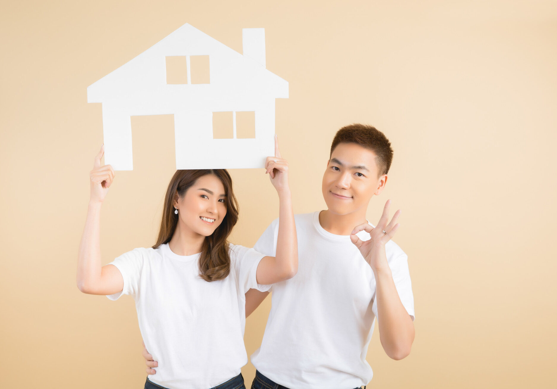 young-happy-asian-couple-presenting-symbols-house young-happy-asian-couple-presenting-symbols-house